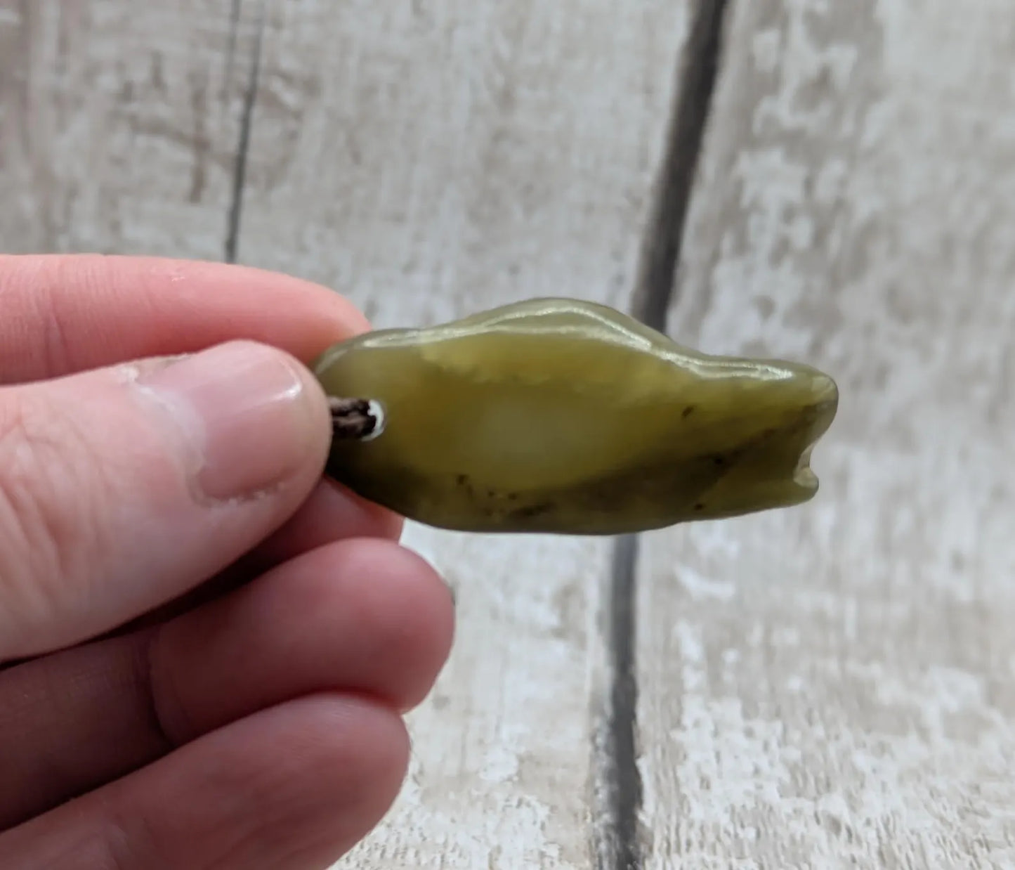 New Zealand tumbled Pounamu greenstone pendant.