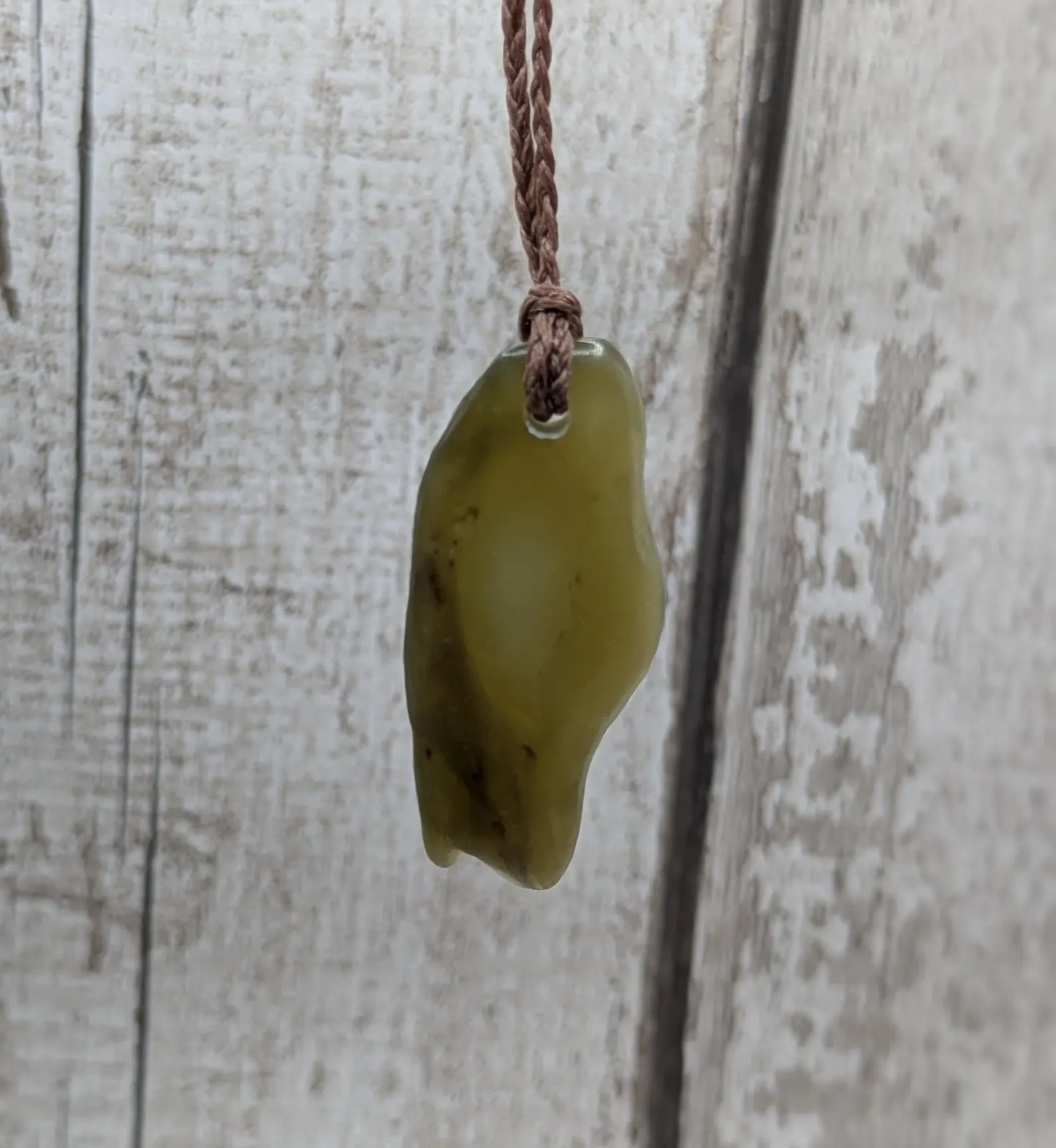 New Zealand tumbled Pounamu greenstone pendant.