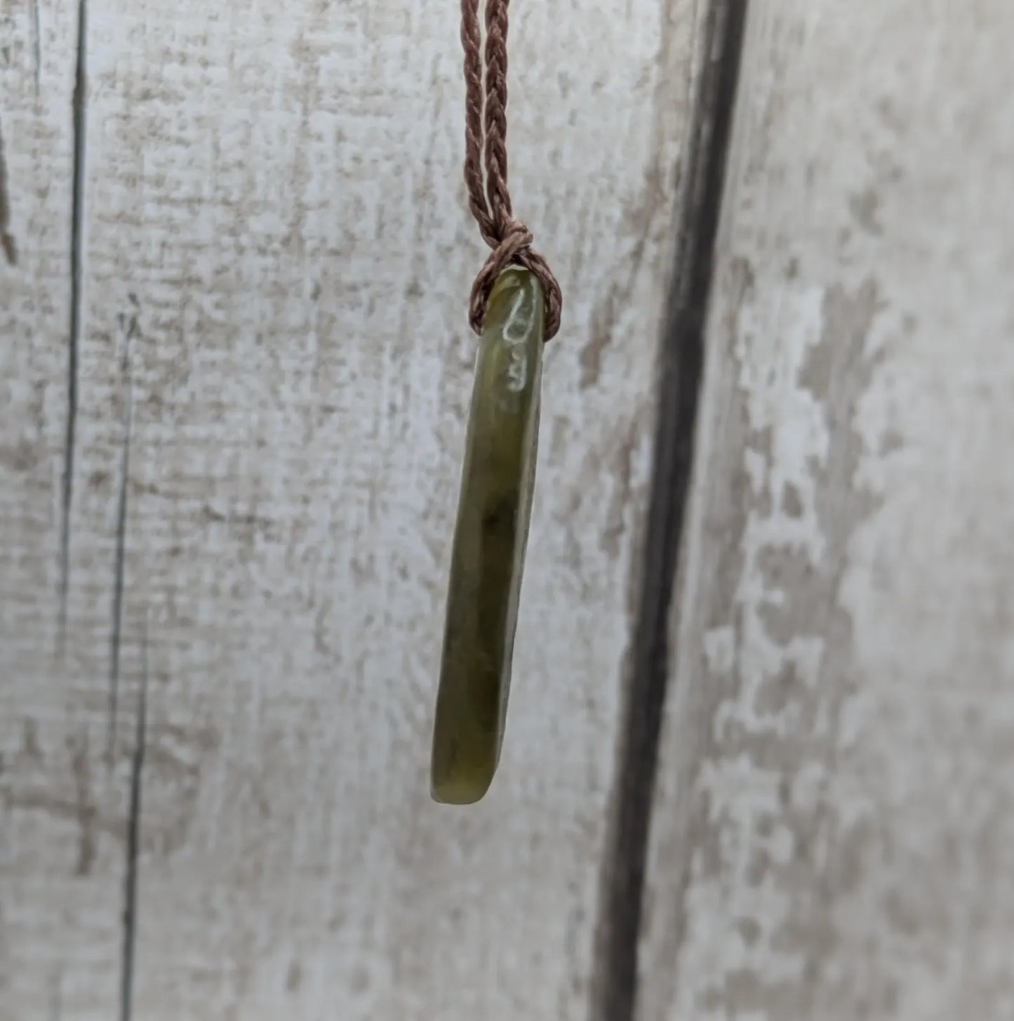 New Zealand tumbled Pounamu greenstone pendant.