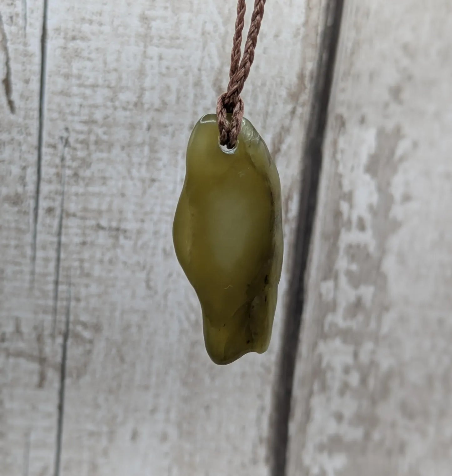 New Zealand tumbled Pounamu greenstone pendant.