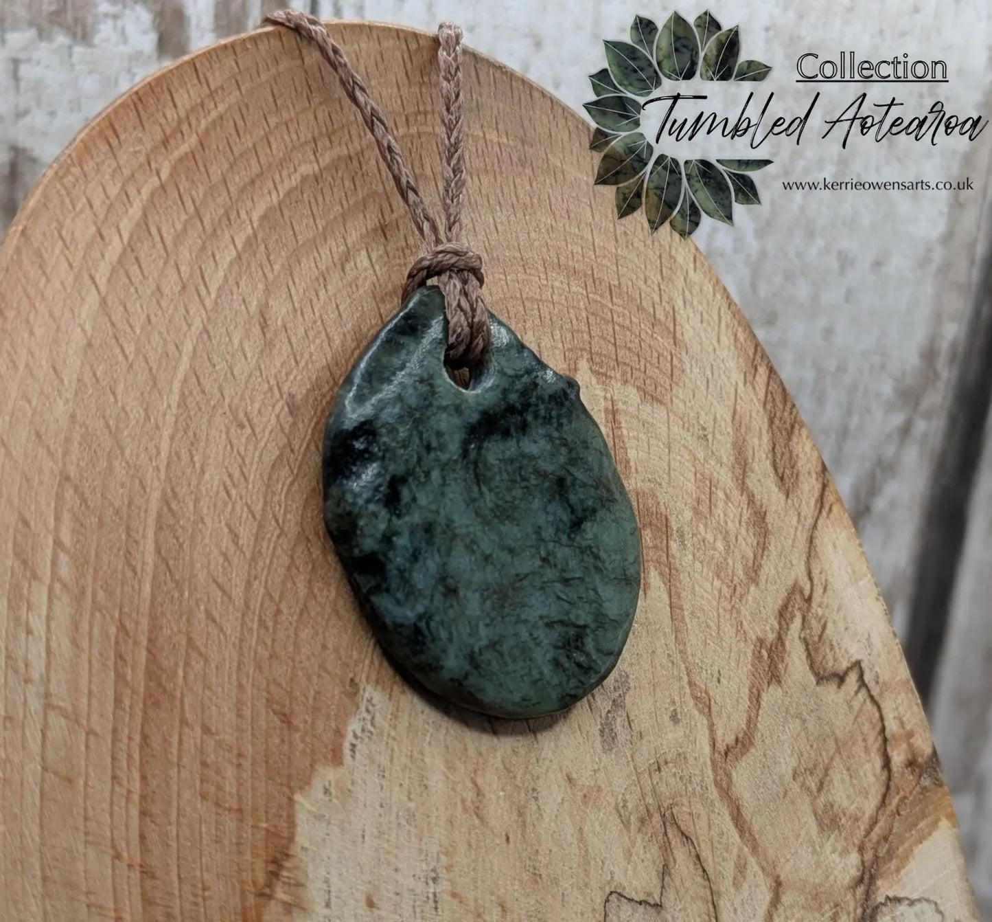 Tumble polished New Zealand Pounamu greenstone pendant.