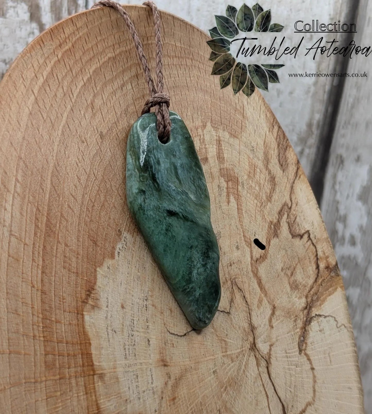 Chatoyant New Zealand tumbled Pounamu greenstone pendant.