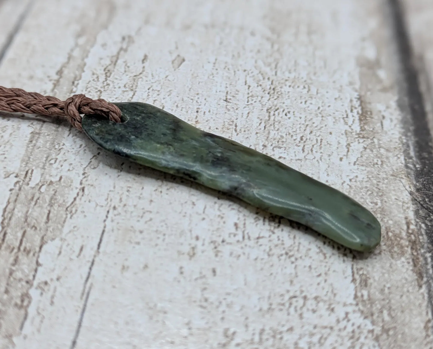 New Zealand Pounamu greenstone tumbled pendant.