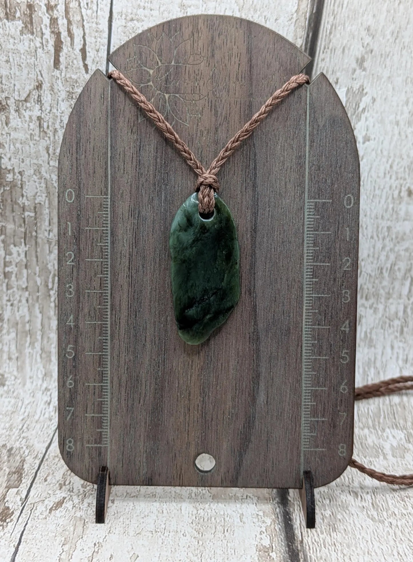 Tumbled Pounamu greenstone nephrite jade pendant.