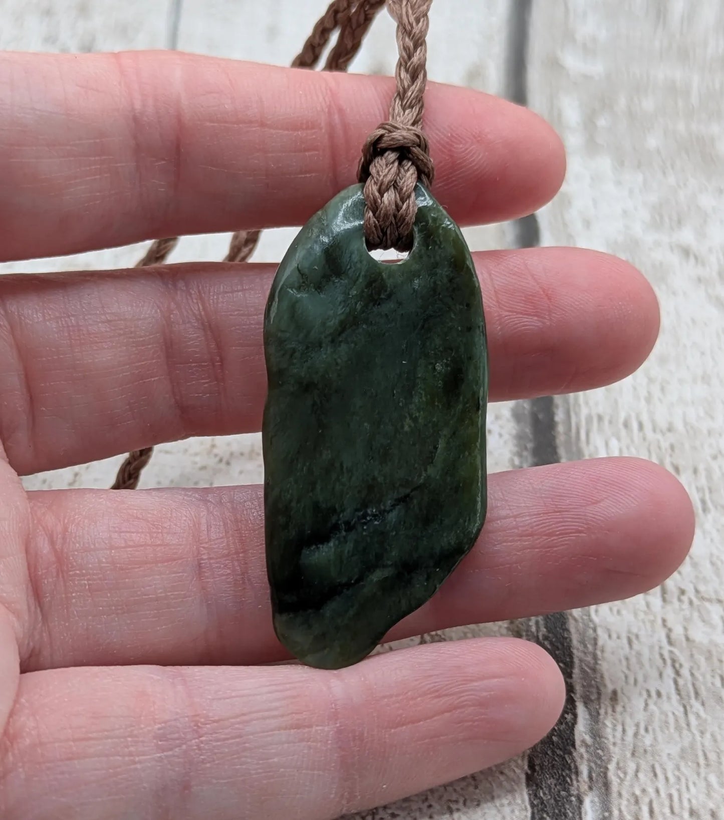 Tumbled Pounamu greenstone nephrite jade pendant.