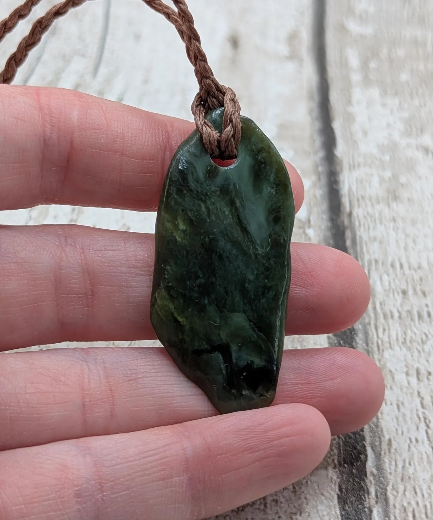 Tumbled Pounamu greenstone nephrite jade pendant.