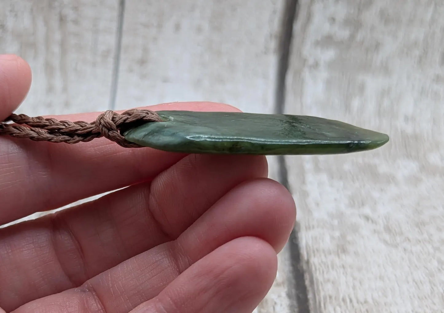 Tumbled Pounamu greenstone nephrite jade pendant.