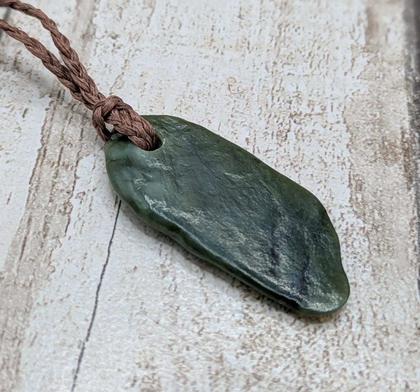 Tumbled Pounamu greenstone nephrite jade pendant.