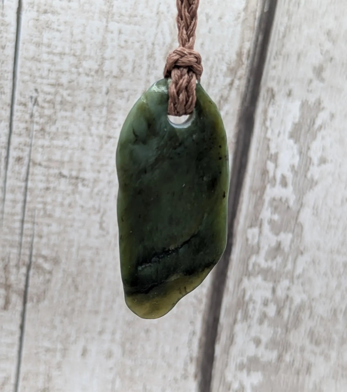 Tumbled Pounamu greenstone nephrite jade pendant.
