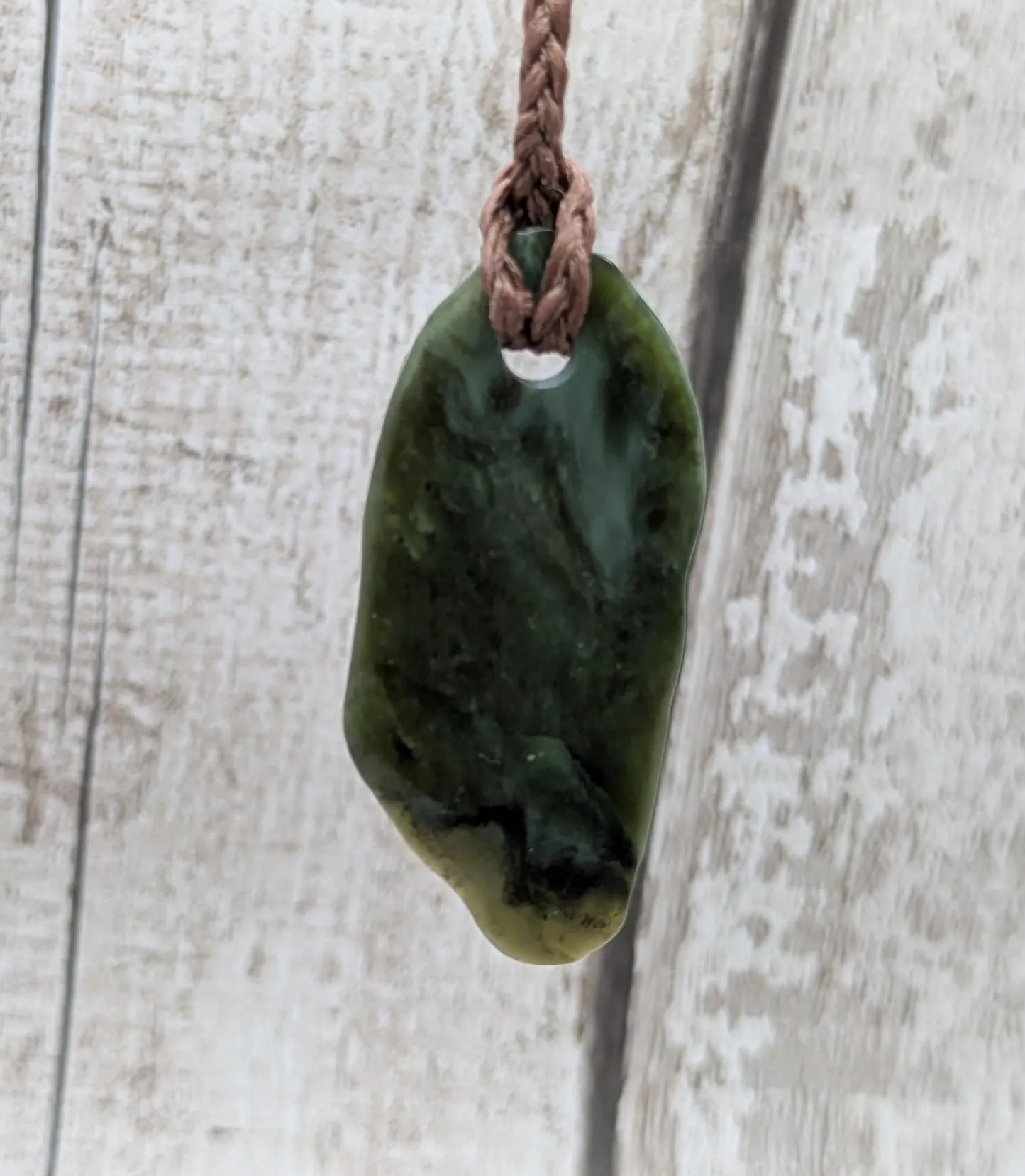 Tumbled Pounamu greenstone nephrite jade pendant.