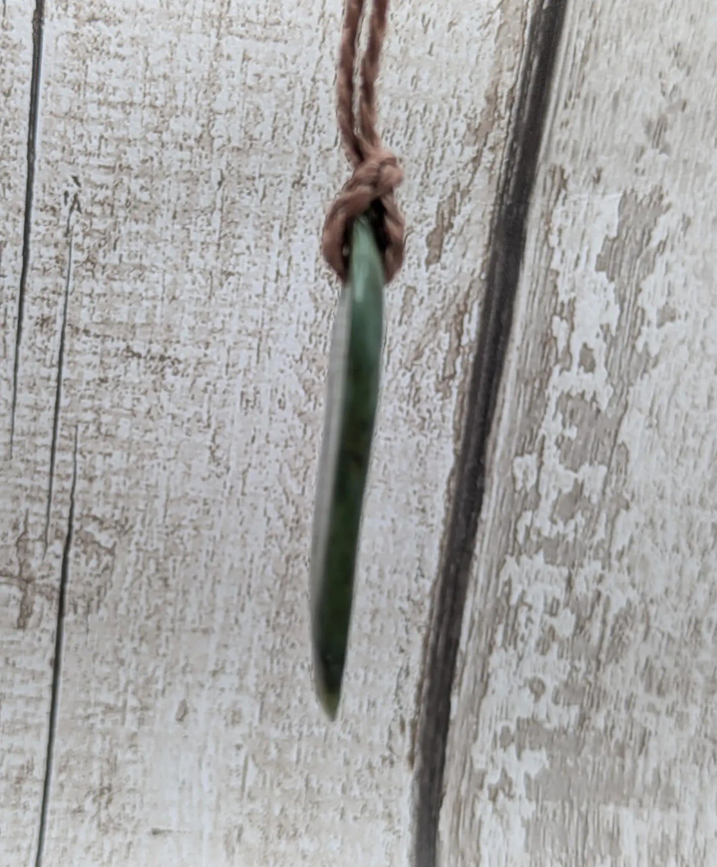 Tumbled Pounamu greenstone nephrite jade pendant.