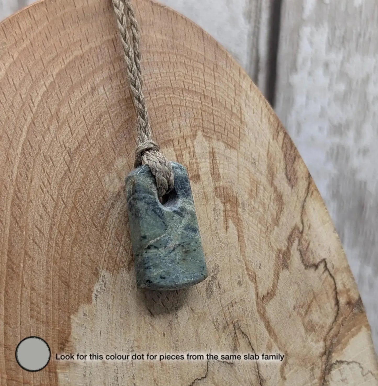 Tiny New Zealand greenstone jade roimata pendant.