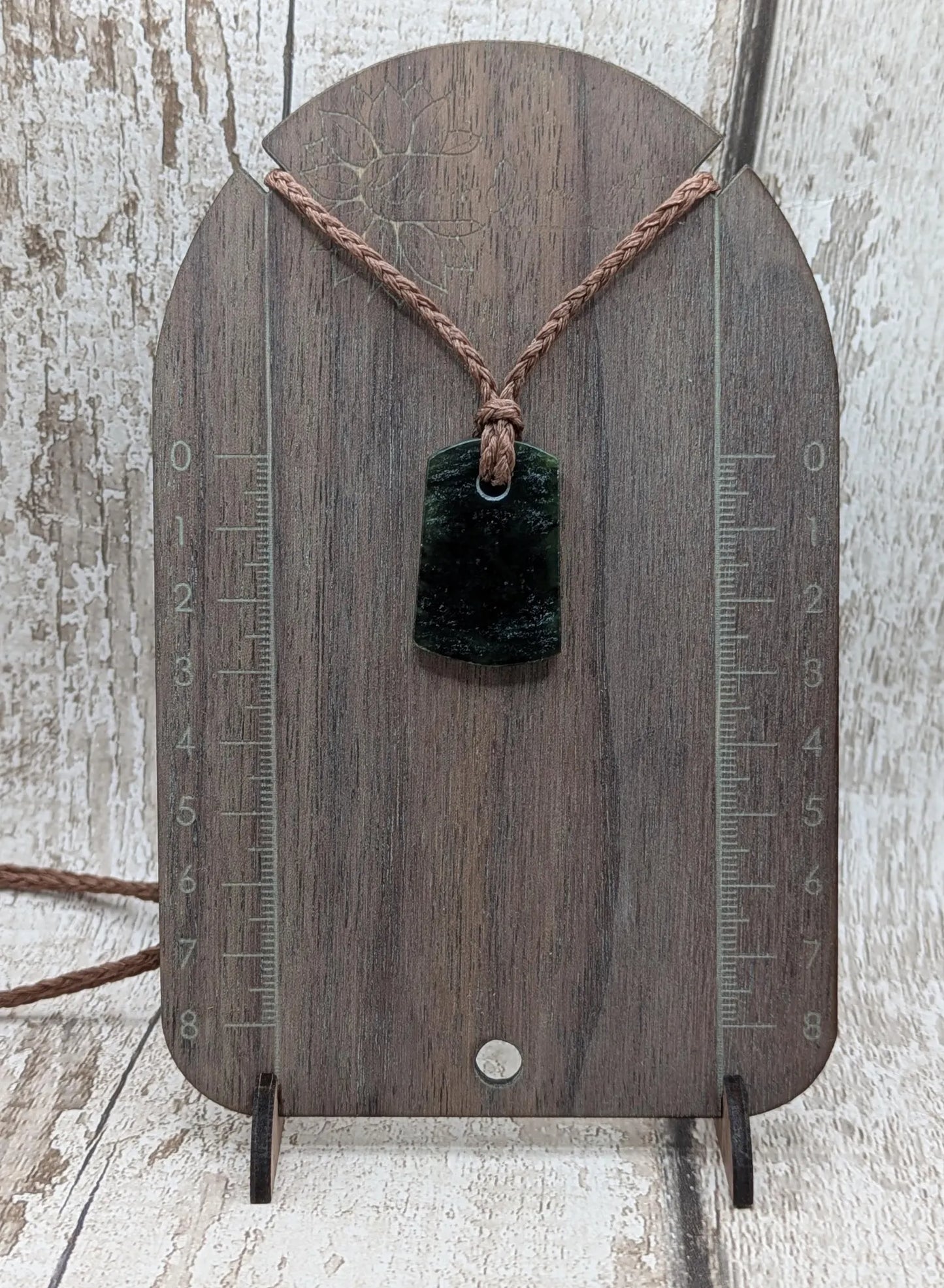 New Zealand Pounamu greenstone slice pendant.