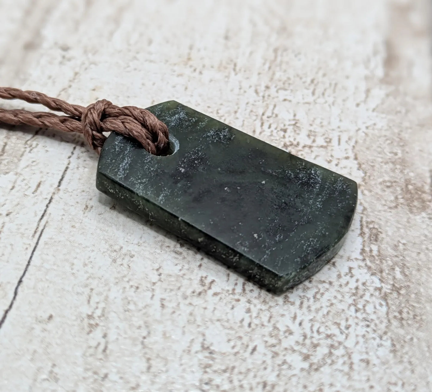 New Zealand Pounamu greenstone slice pendant.