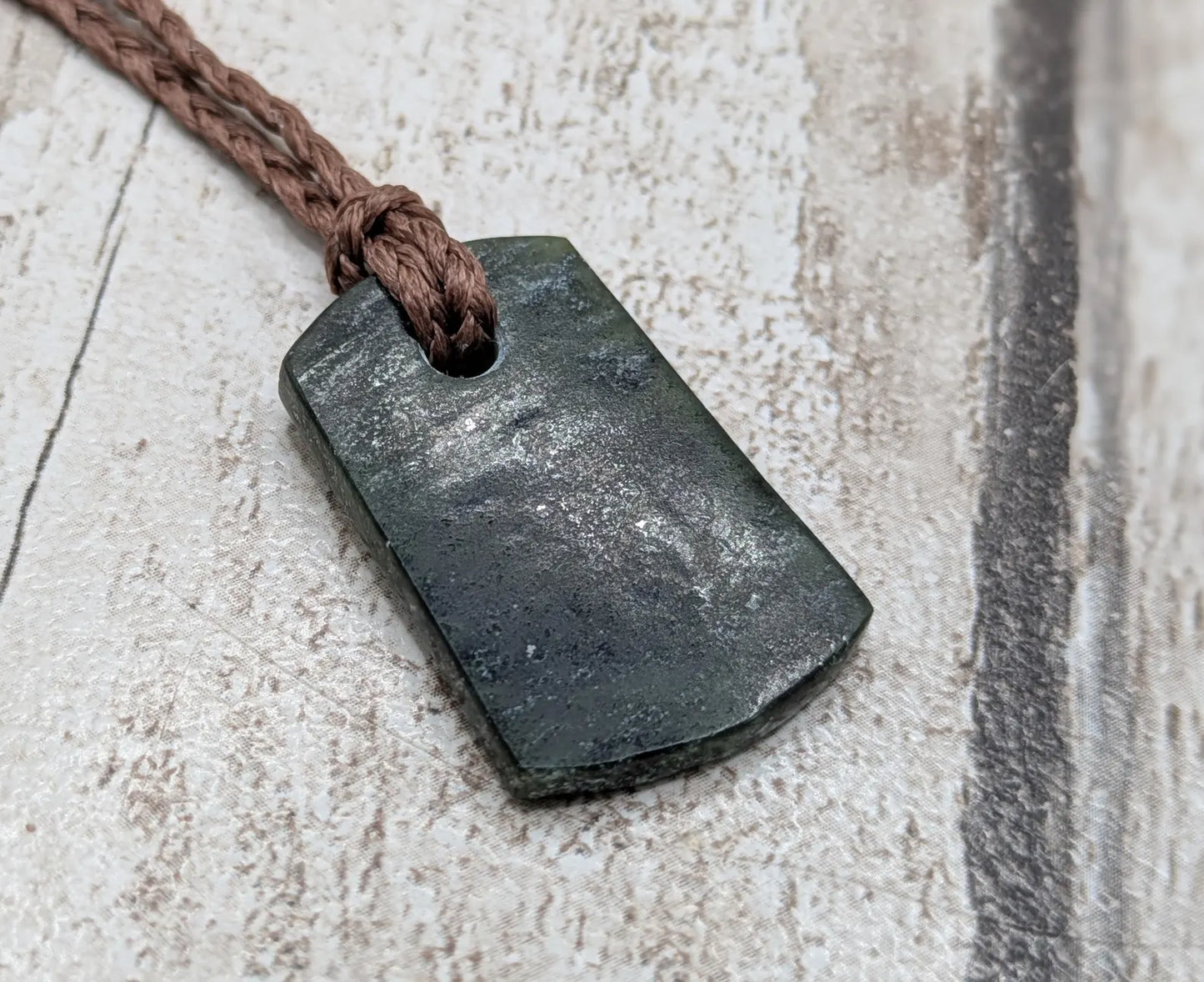 New Zealand Pounamu greenstone slice pendant.
