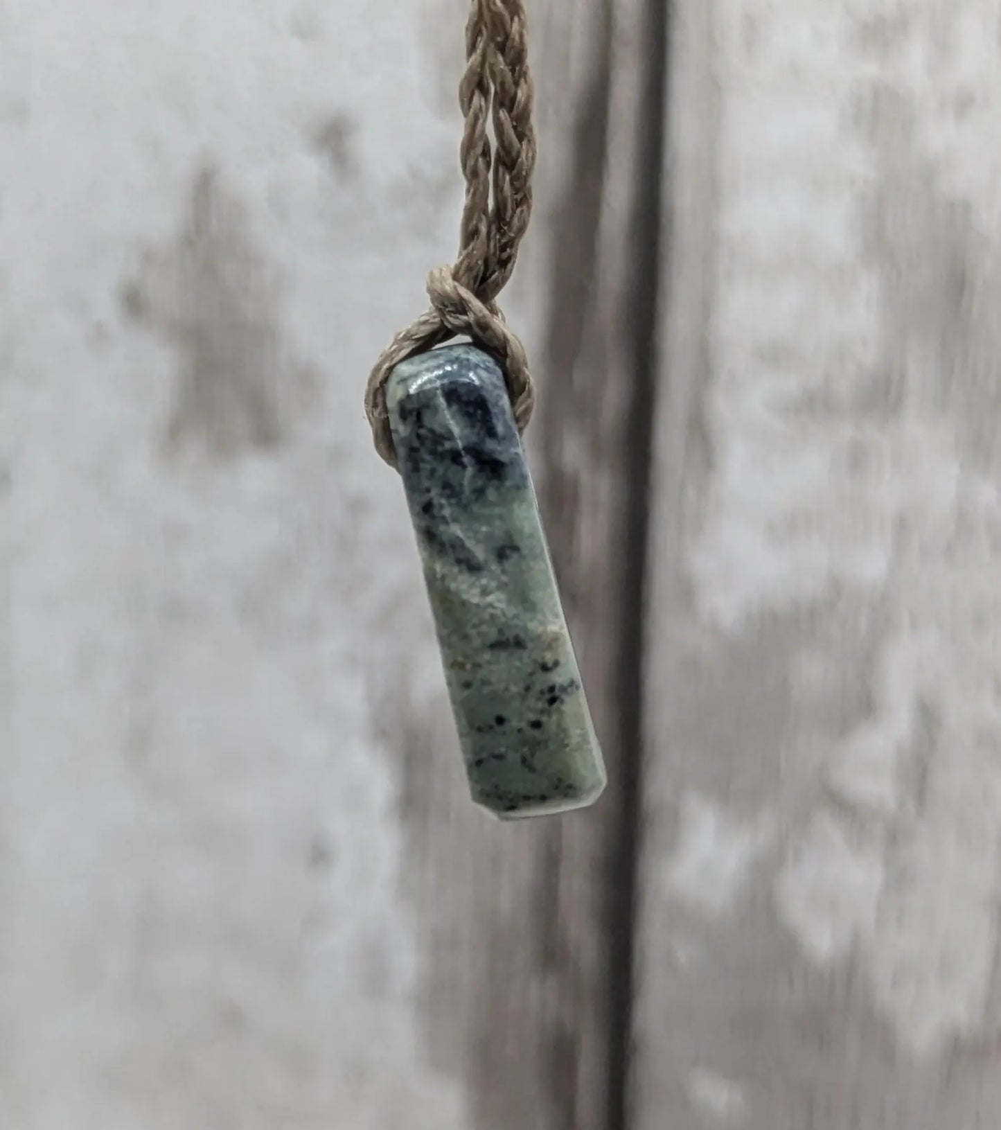 Tiny New Zealand greenstone jade roimata pendant.