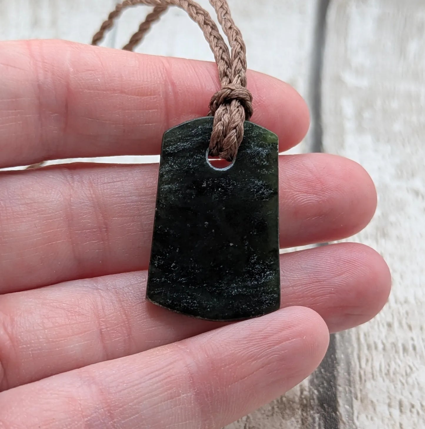 New Zealand Pounamu greenstone slice pendant.