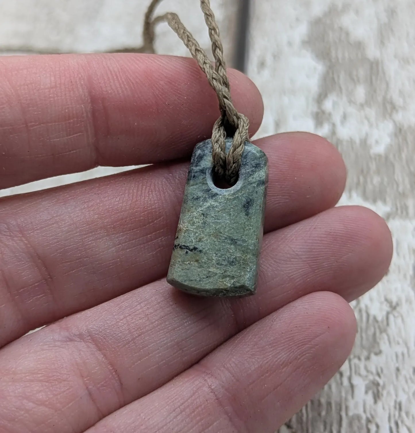 Tiny New Zealand greenstone jade roimata pendant.