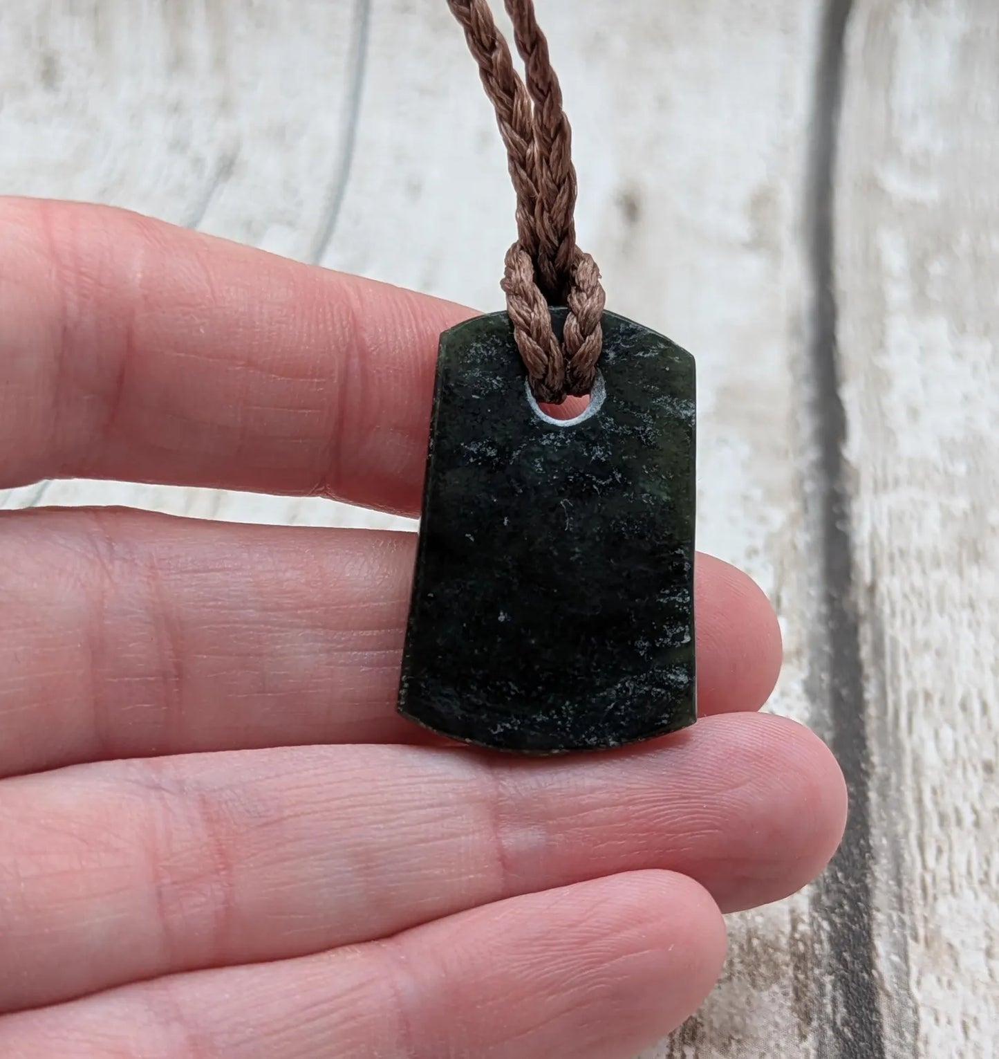 New Zealand Pounamu greenstone slice pendant.