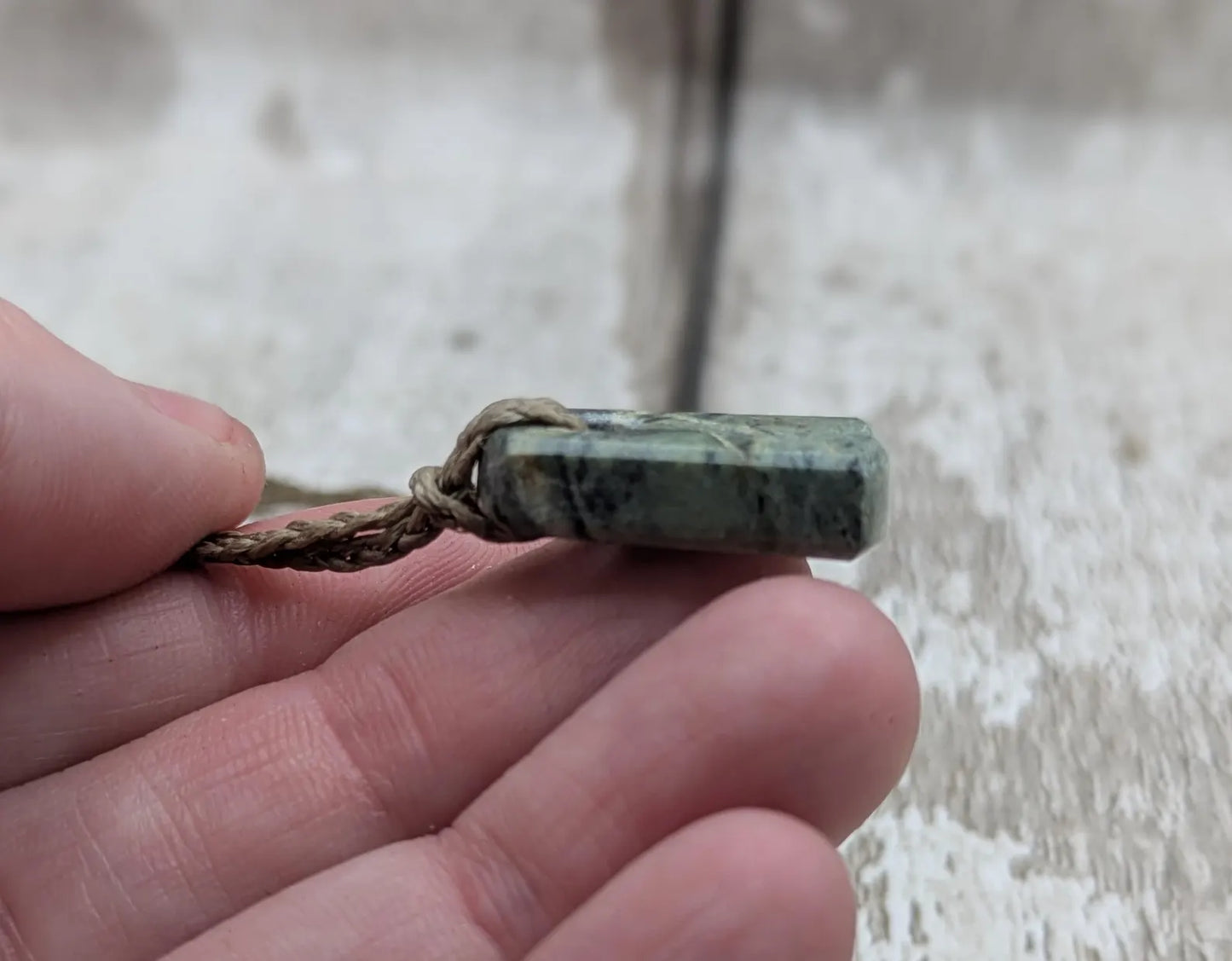 Tiny New Zealand greenstone jade roimata pendant.