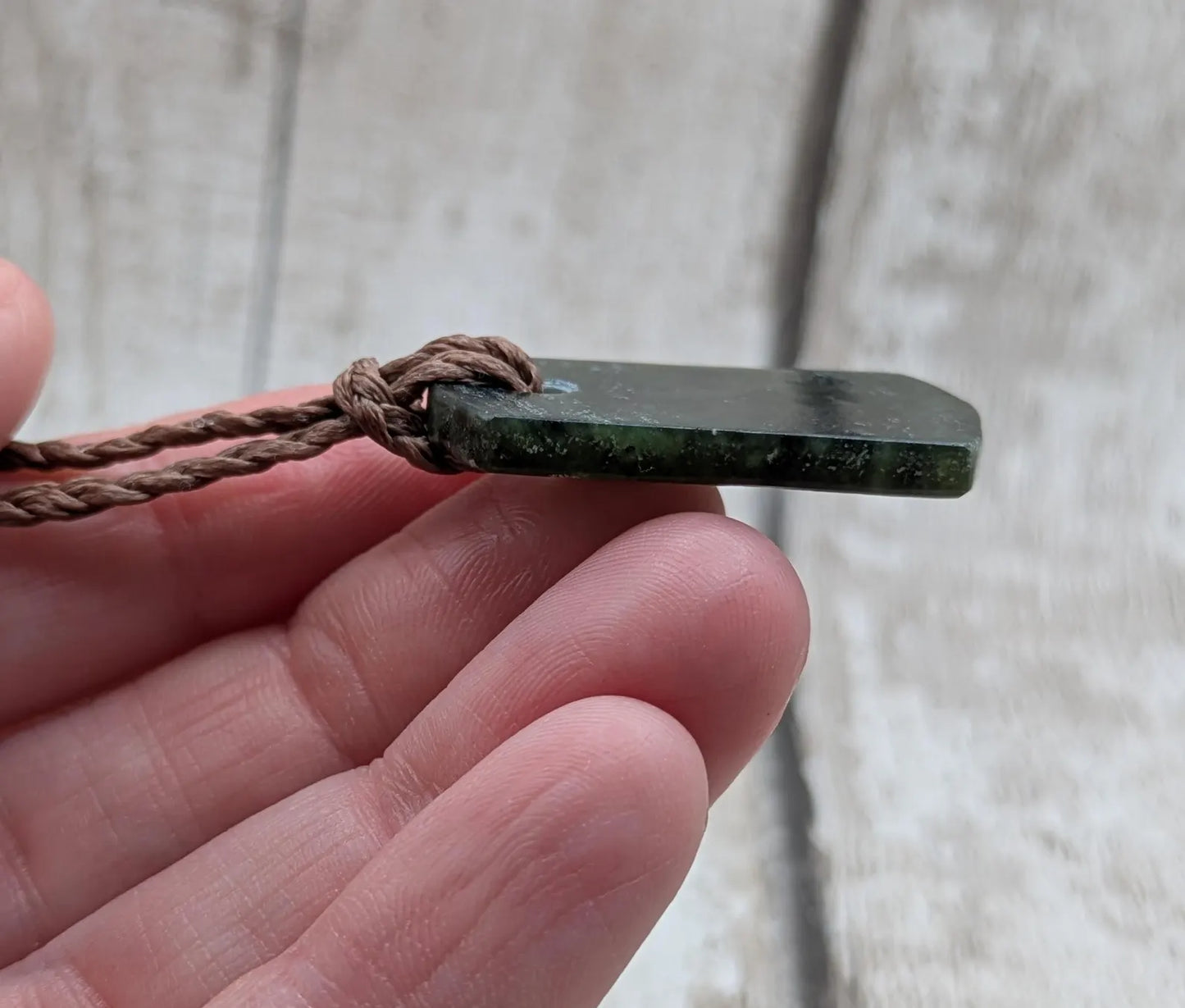 New Zealand Pounamu greenstone slice pendant.