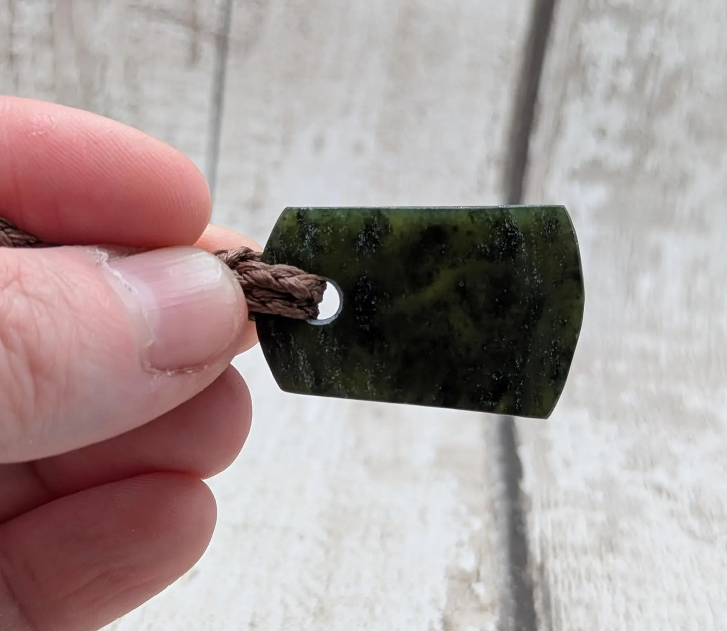 New Zealand Pounamu greenstone slice pendant.