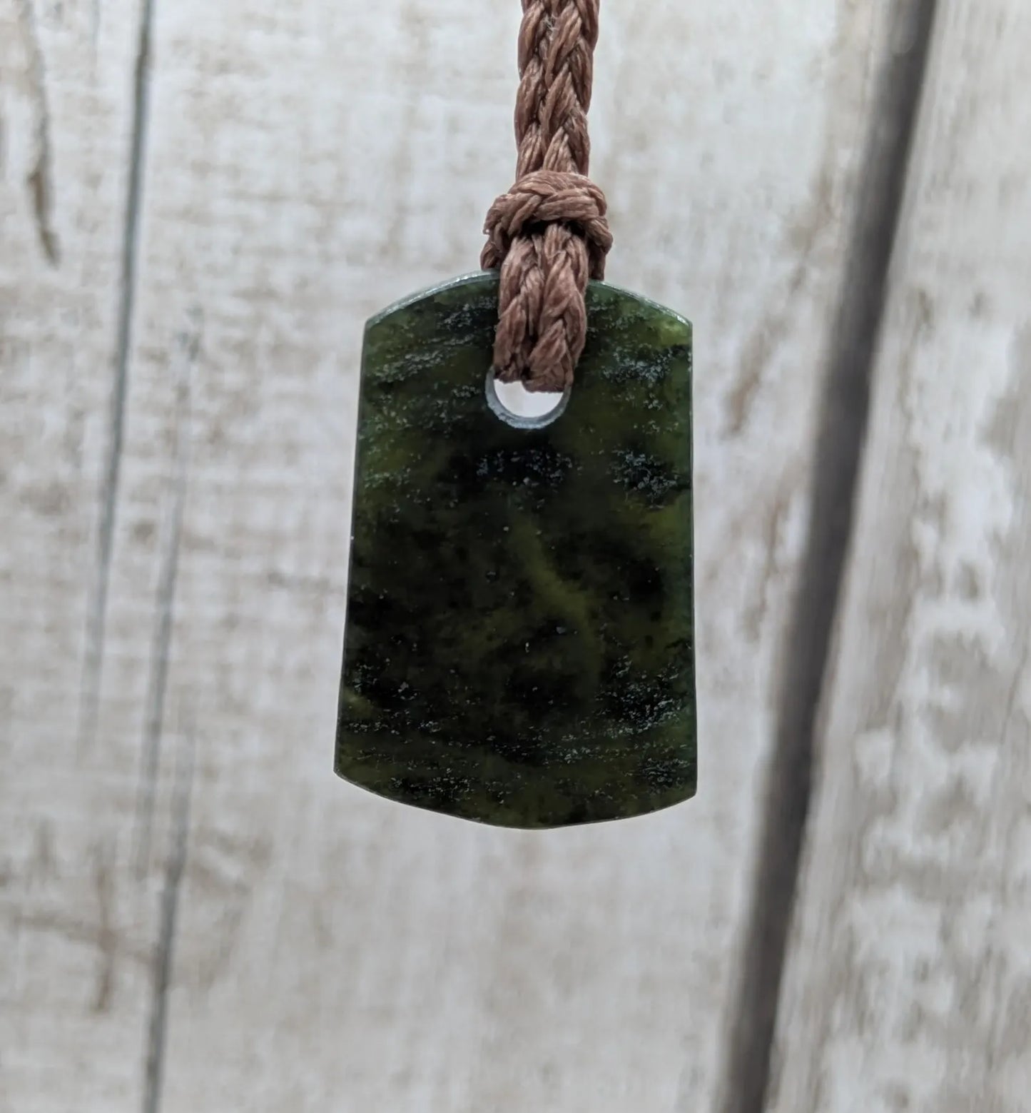 New Zealand Pounamu greenstone slice pendant.