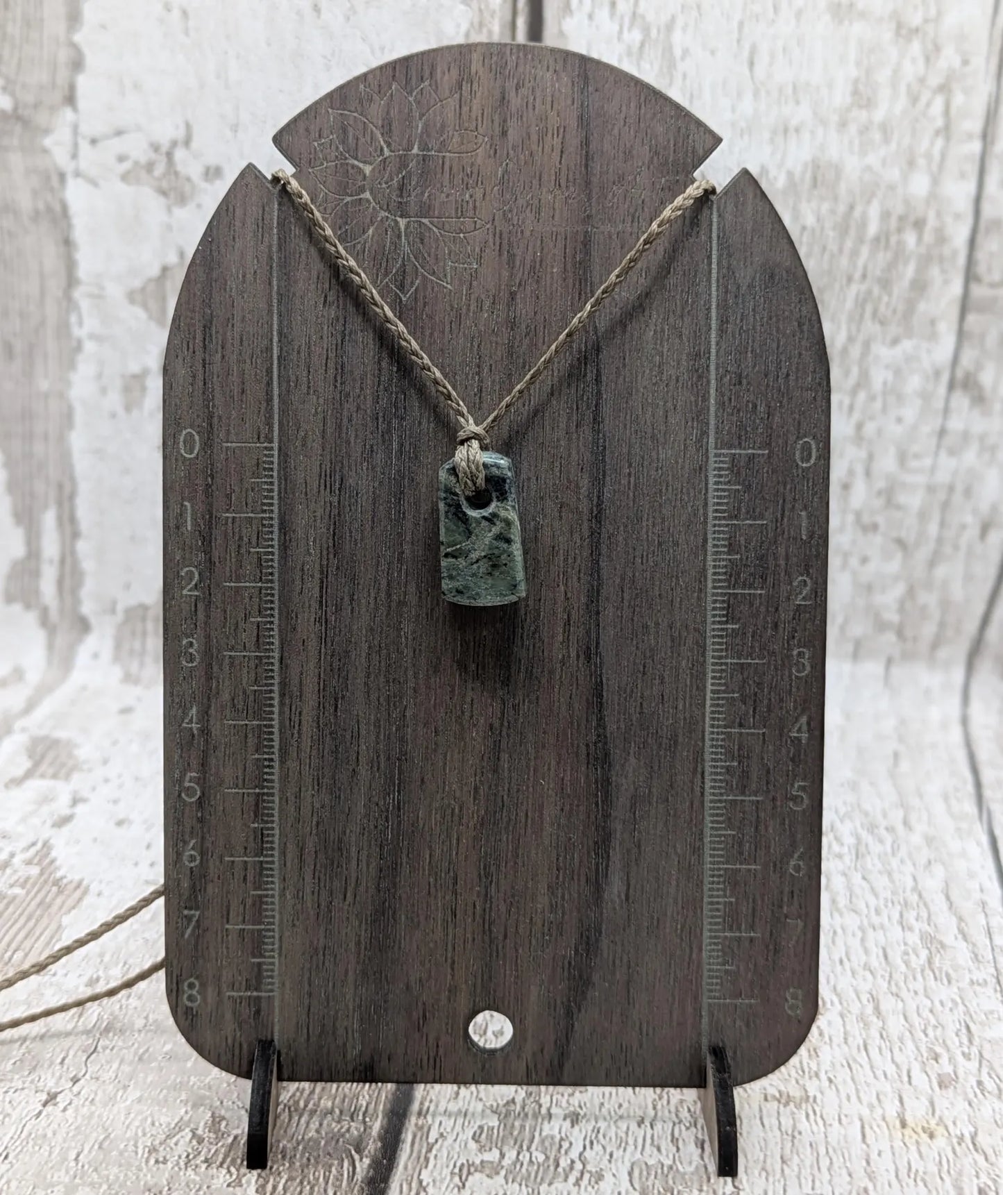 Tiny New Zealand greenstone jade roimata pendant.