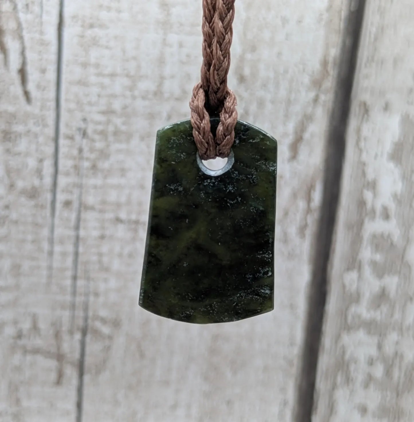 New Zealand Pounamu greenstone slice pendant.