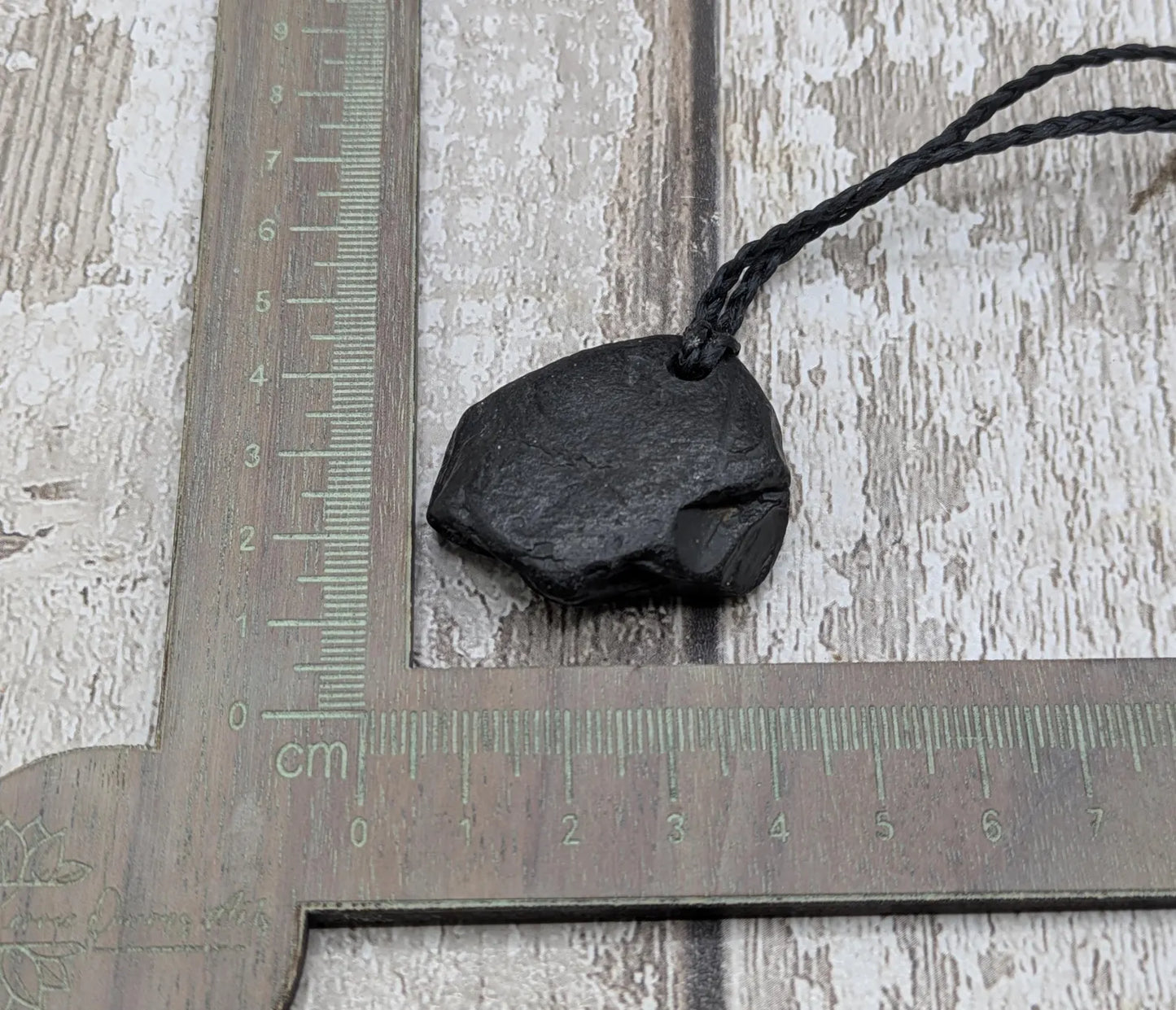 Raw naturally tumbled Whitby jet simple pendant.