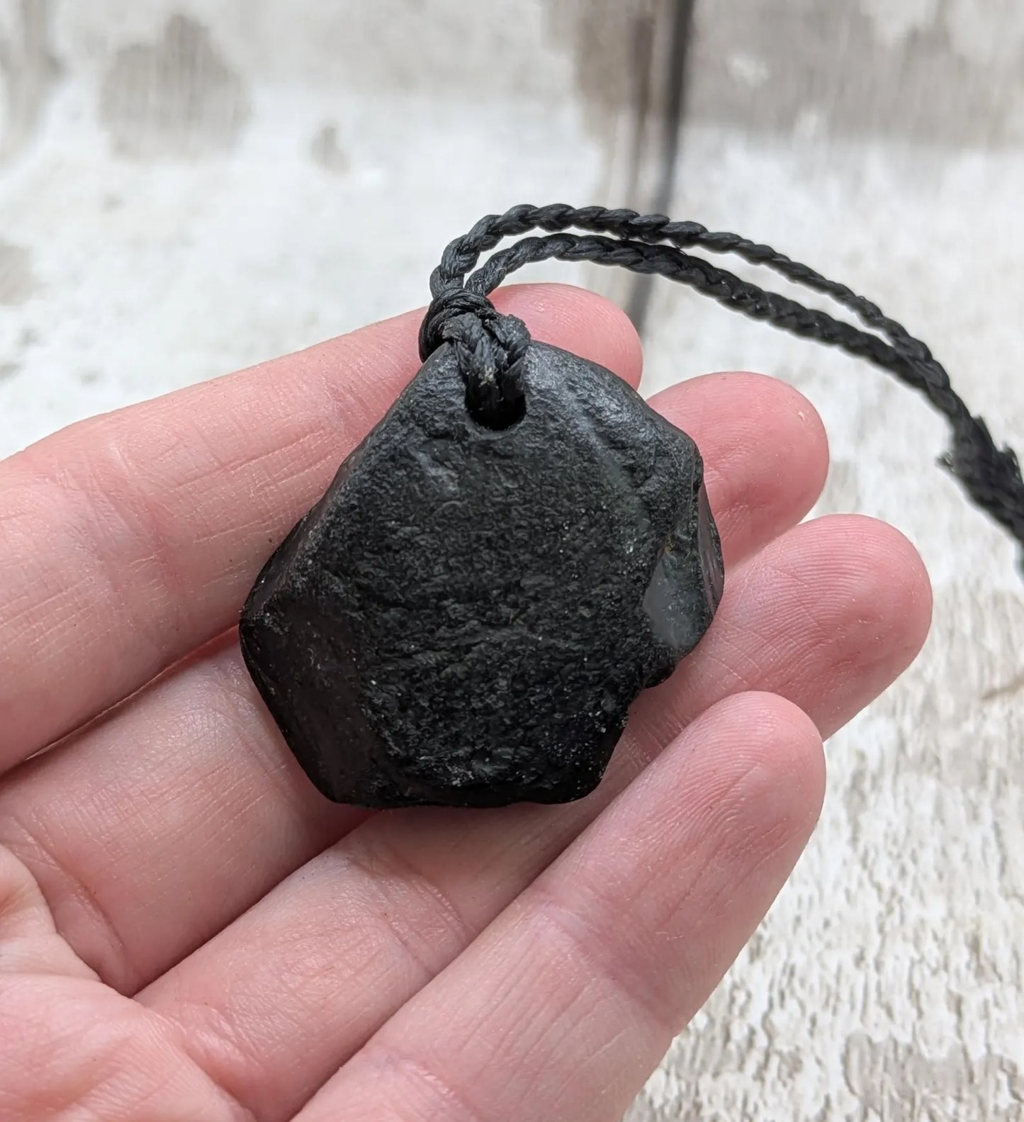 Raw naturally tumbled Whitby jet simple pendant.