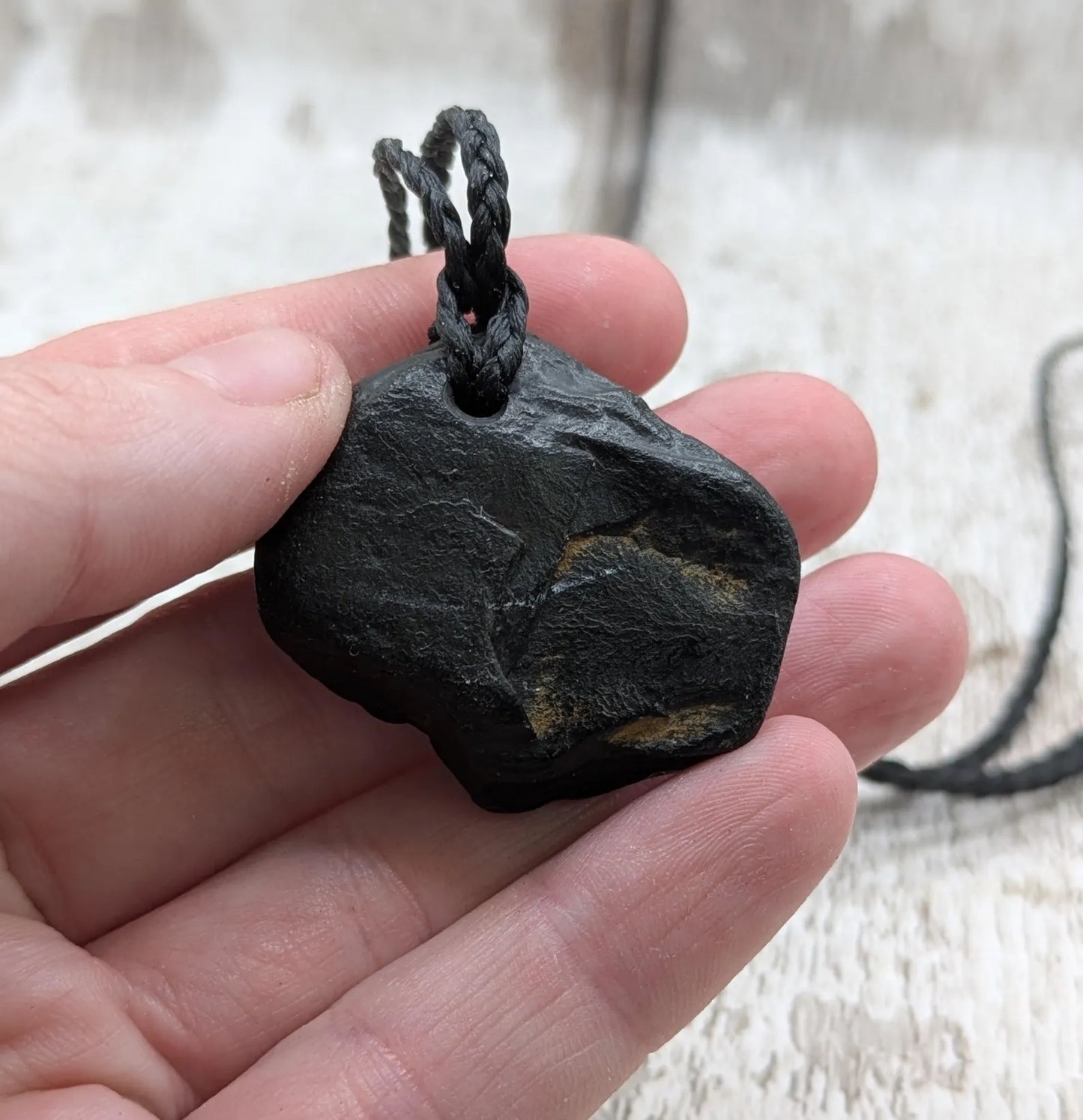 Raw naturally tumbled Whitby jet simple pendant.