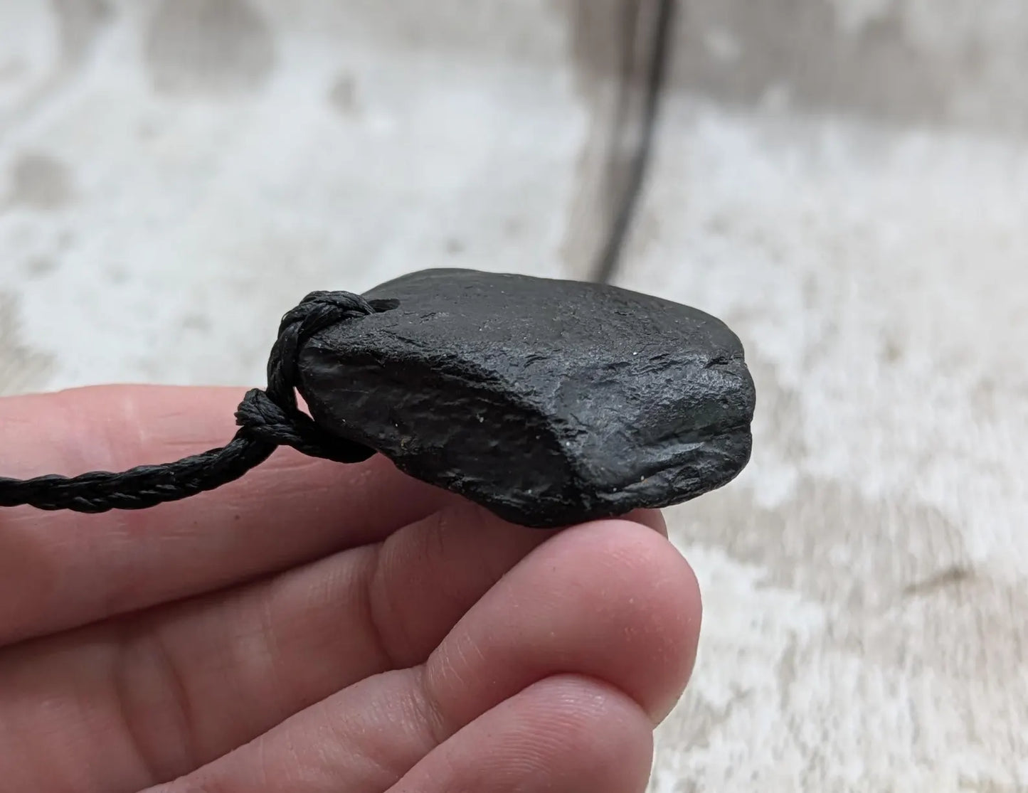 Raw naturally tumbled Whitby jet simple pendant.