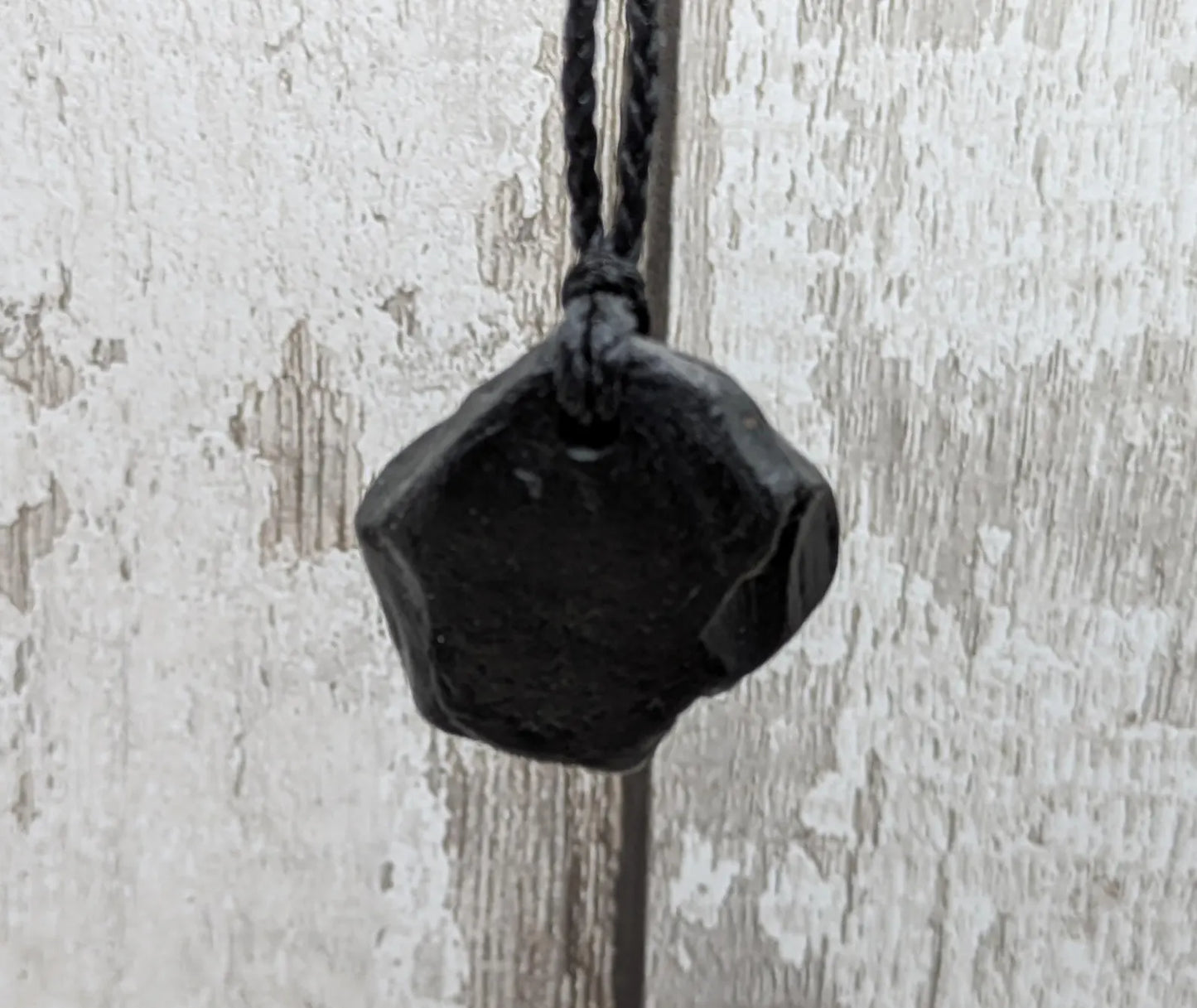 Raw naturally tumbled Whitby jet simple pendant.