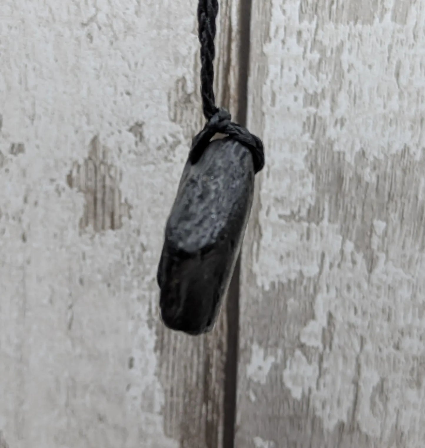 Raw naturally tumbled Whitby jet simple pendant.