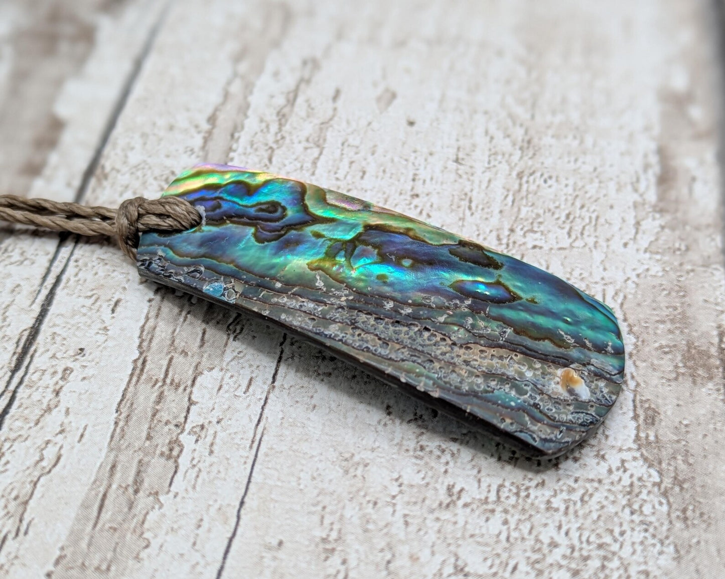 New Zealand Rainbow pāua shell pendant - iridescent abalone necklace, trapezoid shape, oceanic gift, hand crafted jewellery.