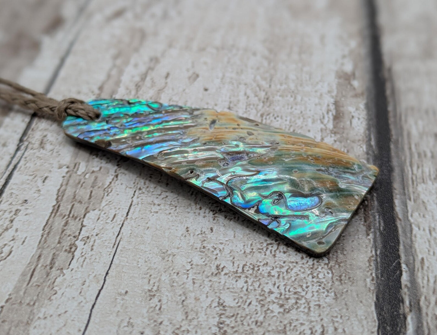New Zealand Rainbow pāua shell pendant - iridescent abalone necklace, trapezoid shape, oceanic gift, hand crafted jewellery.