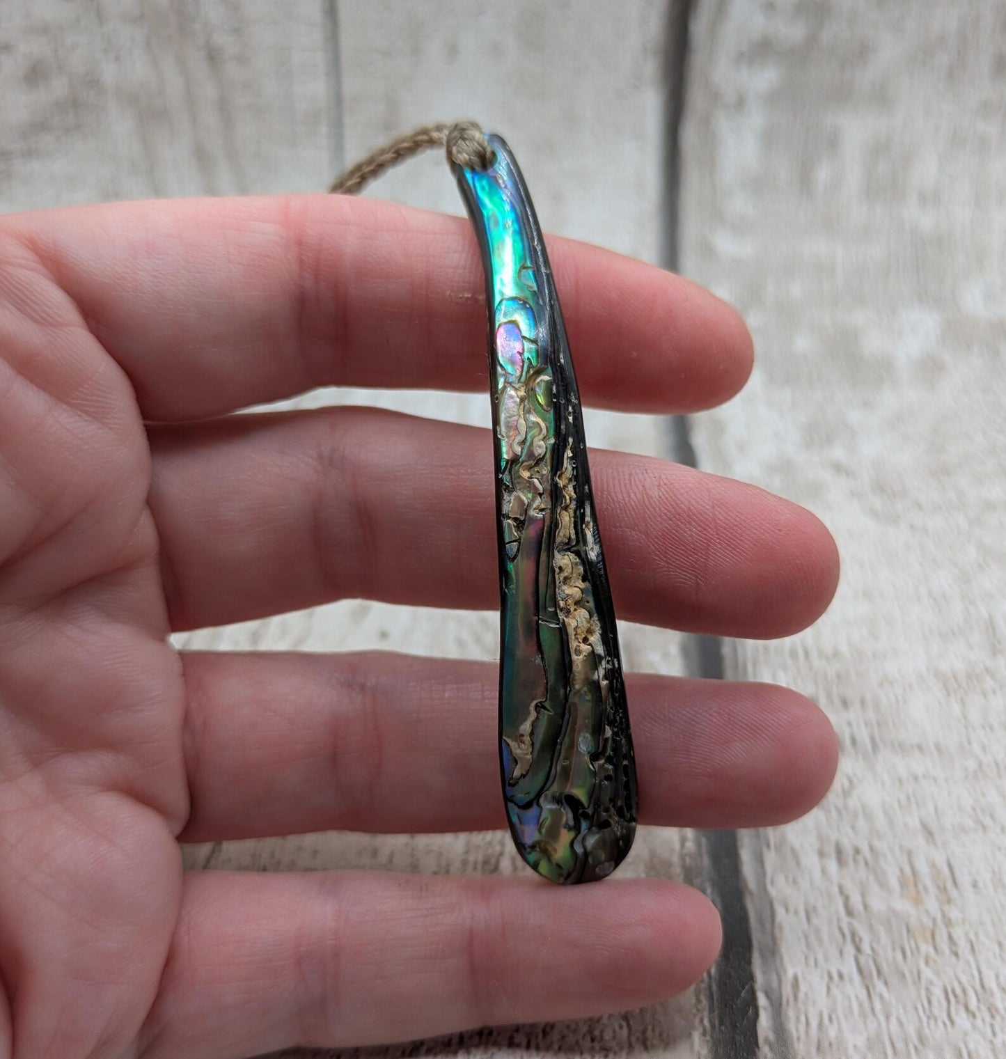 New Zealand rainbow pāua rim drop pendant.