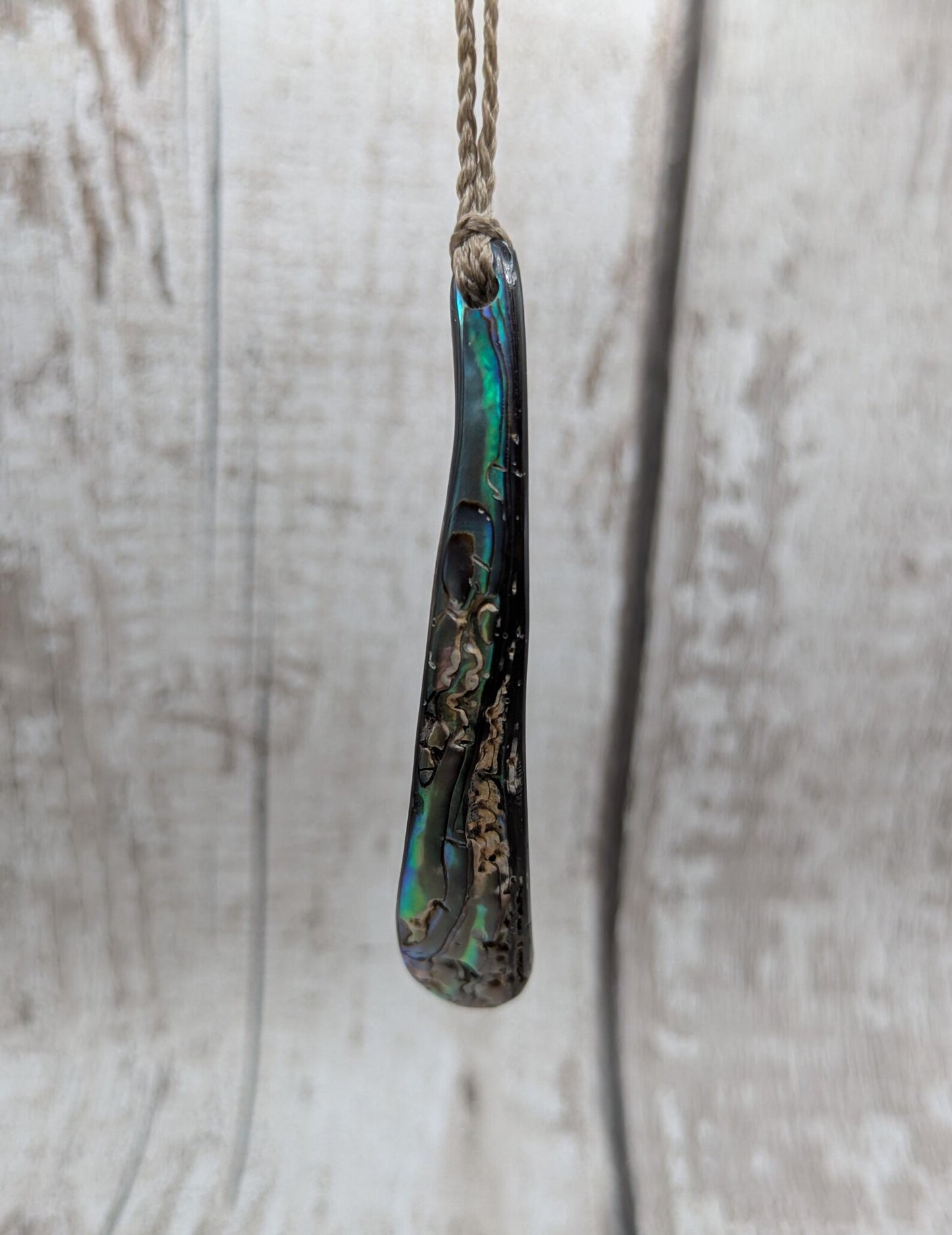 New Zealand rainbow pāua rim drop pendant.