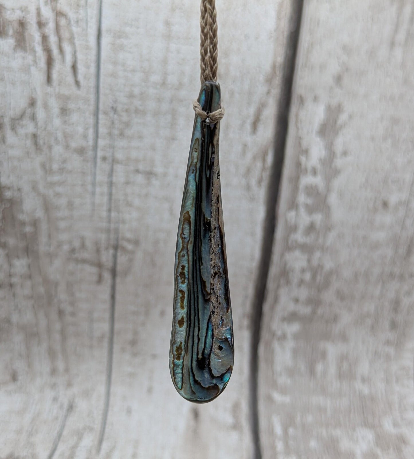 New Zealand rainbow pāua rim drop pendant.