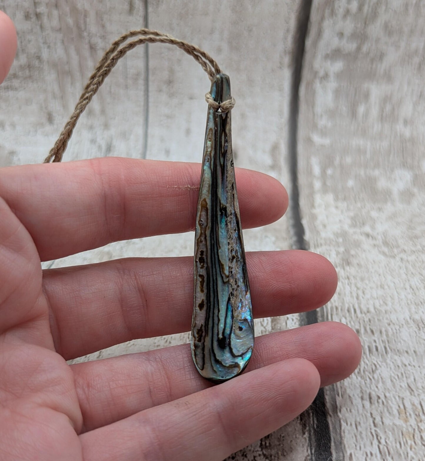 New Zealand rainbow pāua rim drop pendant.