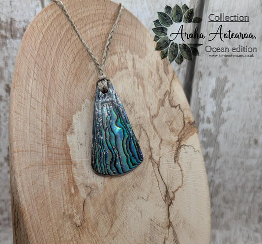 Small New Zealand Pāua Shell Triangle Pendant – Iridescent Abalone Necklace on Adjustable Waxed Cord, ocean themed, natural pattern.