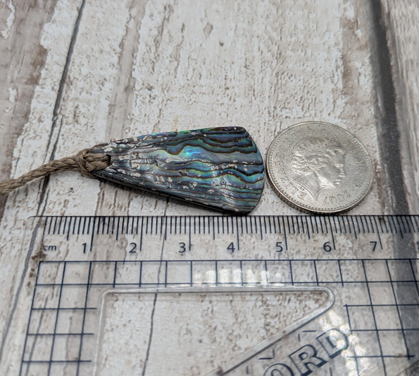 Small New Zealand Pāua Shell Triangle Pendant – Iridescent Abalone Necklace on Adjustable Waxed Cord, ocean themed, natural pattern.
