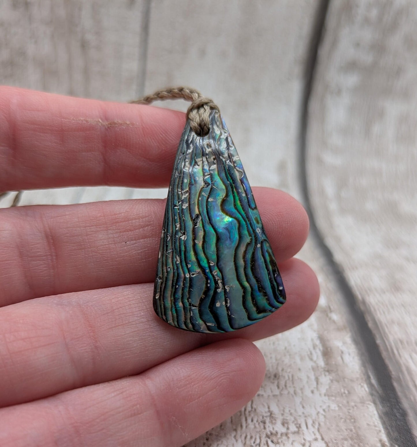 Small New Zealand Pāua Shell Triangle Pendant – Iridescent Abalone Necklace on Adjustable Waxed Cord, ocean themed, natural pattern.
