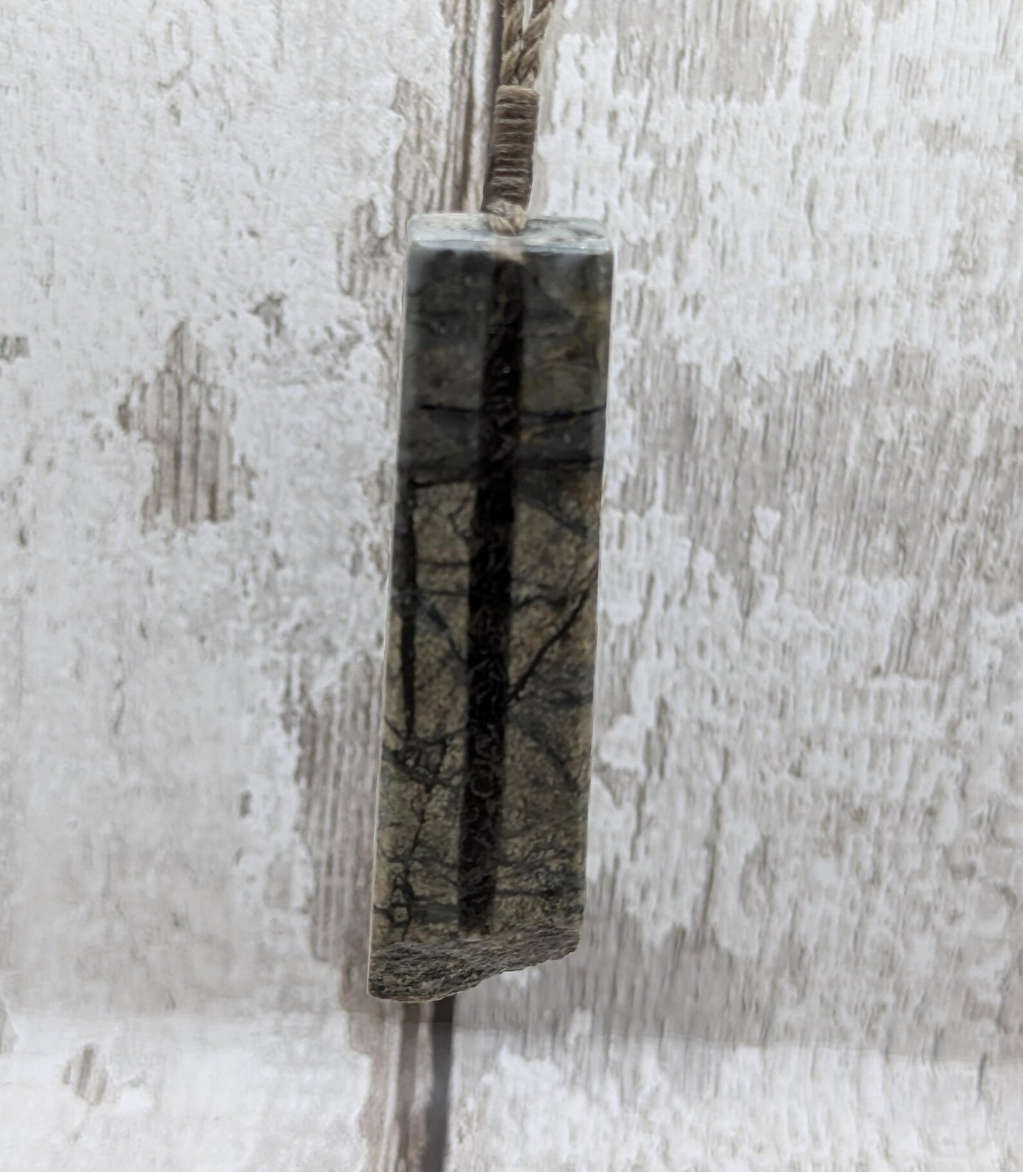 Impactite pendant with mixed tektites and meteorite specimen.