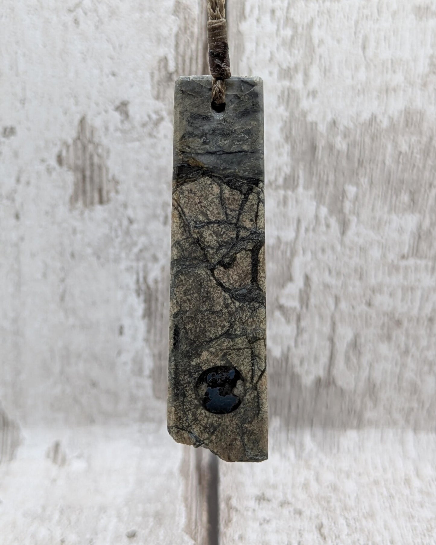 Impactite pendant with mixed tektites and meteorite specimen.