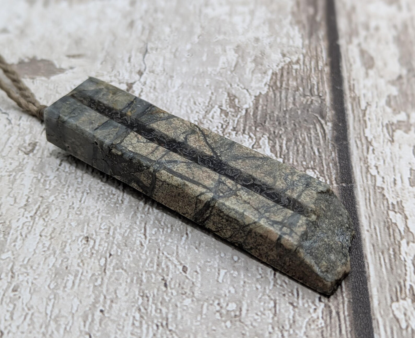 Impactite pendant with mixed tektites and meteorite specimen.