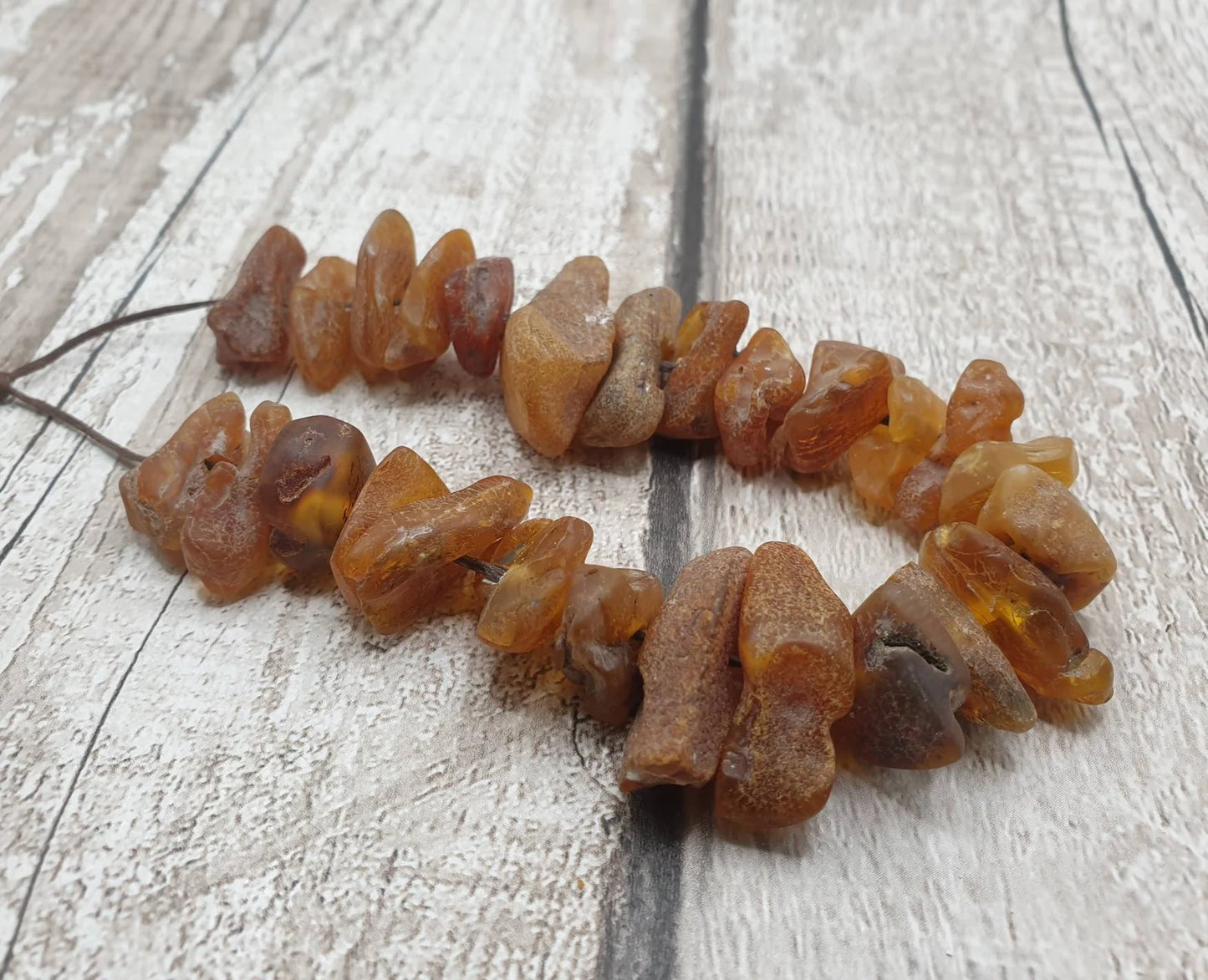 10 Raw natural centre drilled Baltic Amber beads.