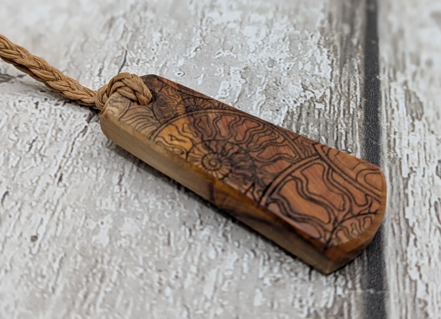 Yew wood laser printed all over ammonite print pendant.