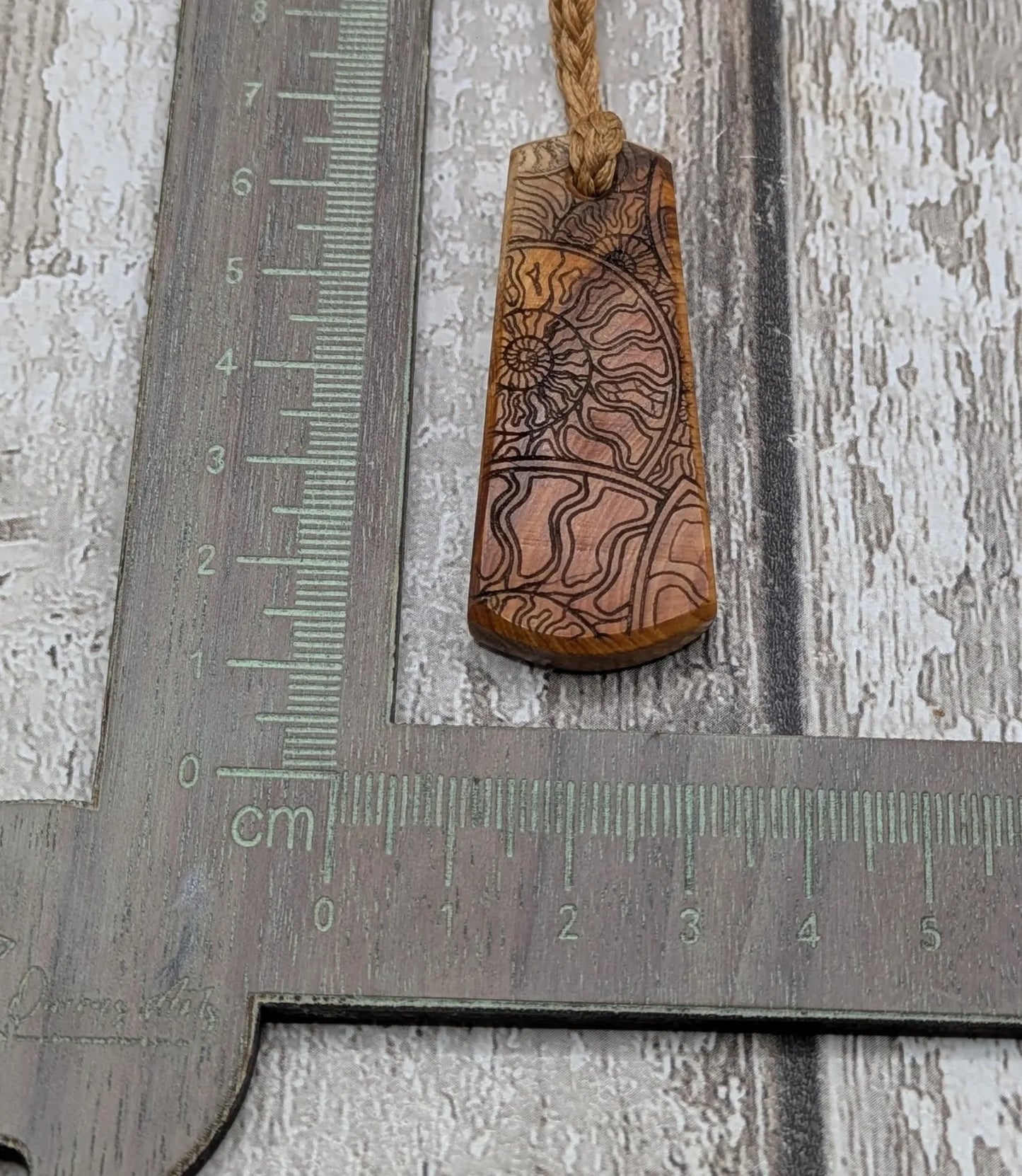 Yew wood laser printed all over ammonite print pendant.